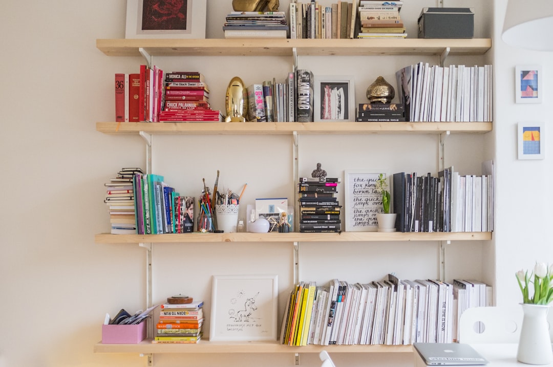 A cluttered kitchen counter with disorganized items and a person organizing it.