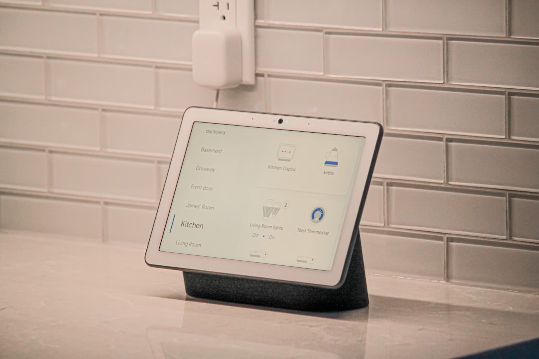 A smart plug connected to a wall outlet with a smartphone displaying a home automation app.